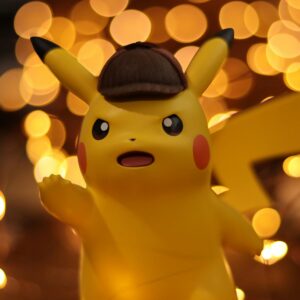 A close-up of a Pikachu figurine illuminated by a warm bokeh effect, creating an eye-catching visual.
