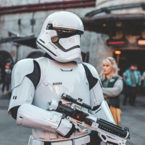 Stormtrooper character in costume at a busy sci-fi themed park event.